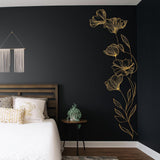 Gold botanical wall decal in a black bedroom, adding elegance and charm to the space.