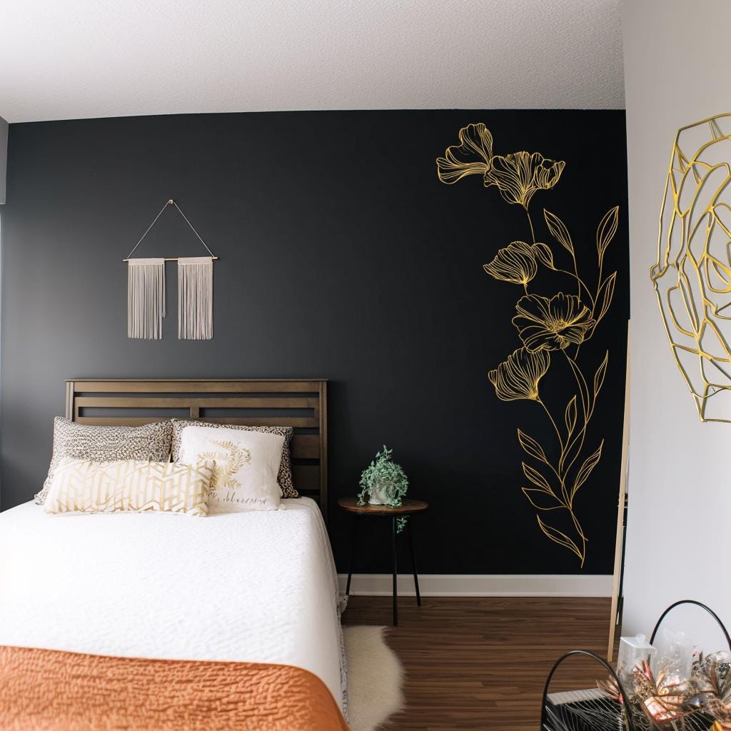 Gold botanical wall decal in minimalist bedroom, elegant floral design accentuating dark wall.