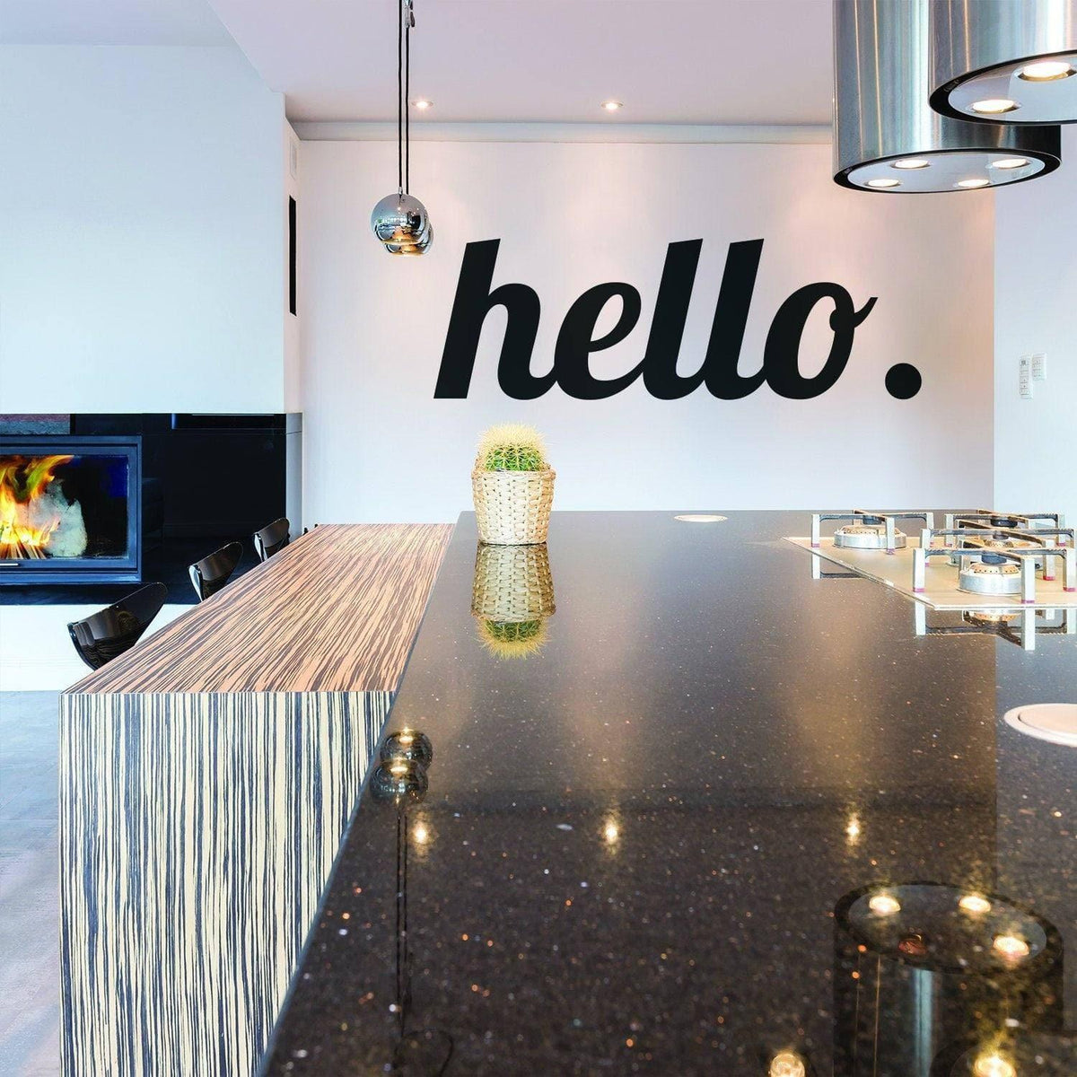 Stylish kitchen with a black 'hello.' wall decal and modern countertop design.