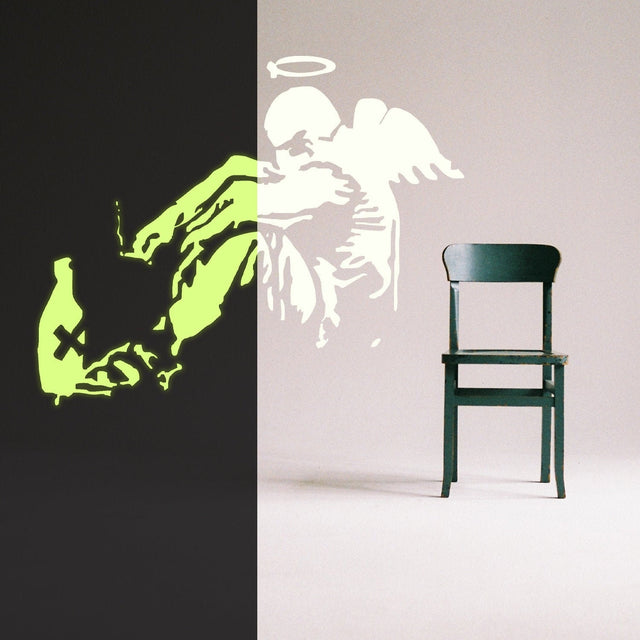 Glow-in-the-dark fallen angel wings wall decal with a street art design.