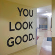 You Look Good vinyl wall sticker displayed on a wall in a hallway, featuring bold inspirational text.