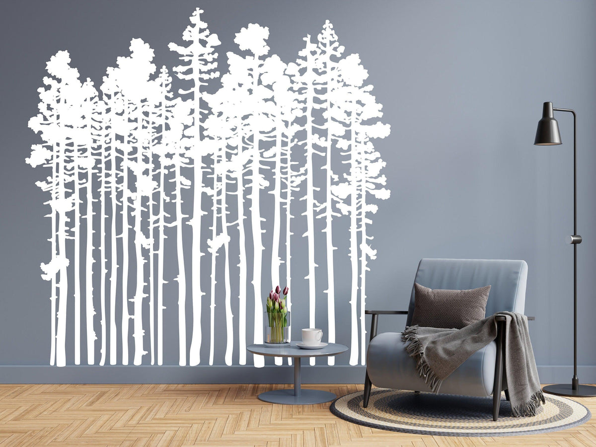 White forest silhouette wall sticker on gray wall, enhancing rustic living room decor with nature-inspired art.