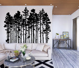 Black pine tree wall decal in modern living room, adding rustic touch to home decor with nature-inspired design.
