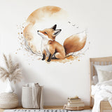 Watercolor baby fox sitting beneath a beige moon wall decal above a wooden child's bed in a nursery.