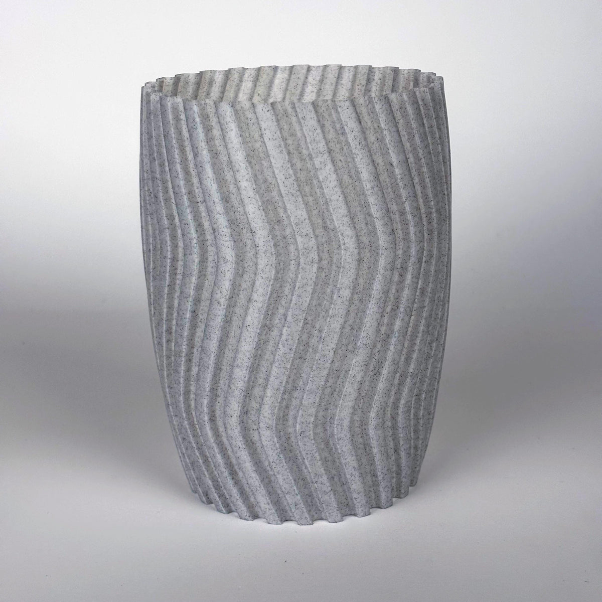 3D printed gray zigzag planter cover with a modern design for indoor plants, enhancing home decor.