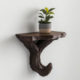 Black 3D printed wall shelf with branching tree supports, mounted as a floating ledge for a small plant.