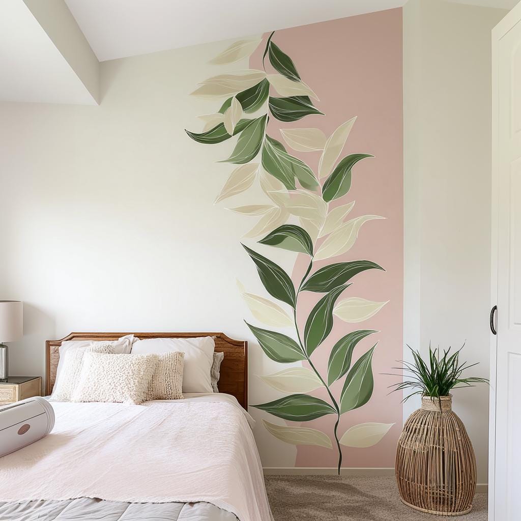 Printed vinyl wall artwork showing oversized green and cream vine leaves in a blush pink composition