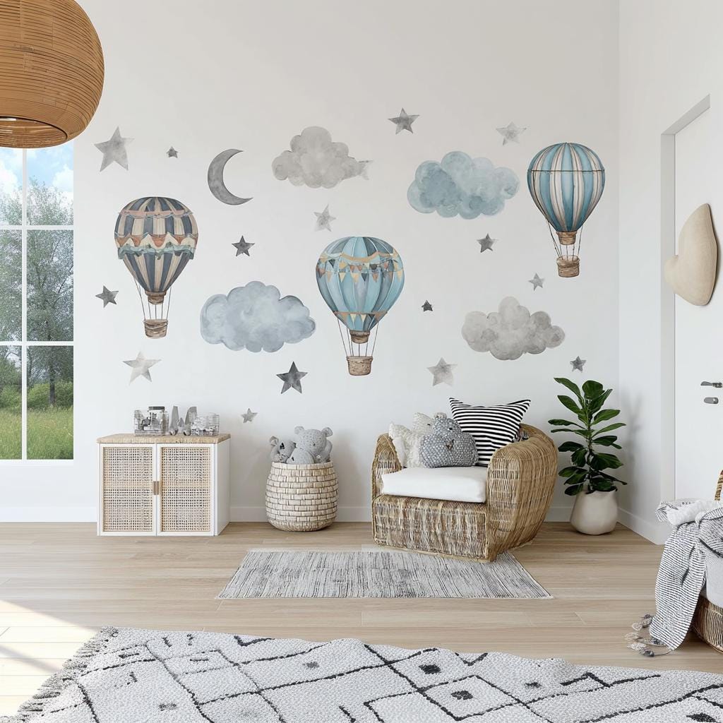 Printed vinyl wall artwork showing vintage watercolor hot air balloons and soft cloud motifs