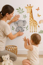 Jungle Animal Wall Decals for Nursery featuring an elephant, giraffe and jungle botanical leaves