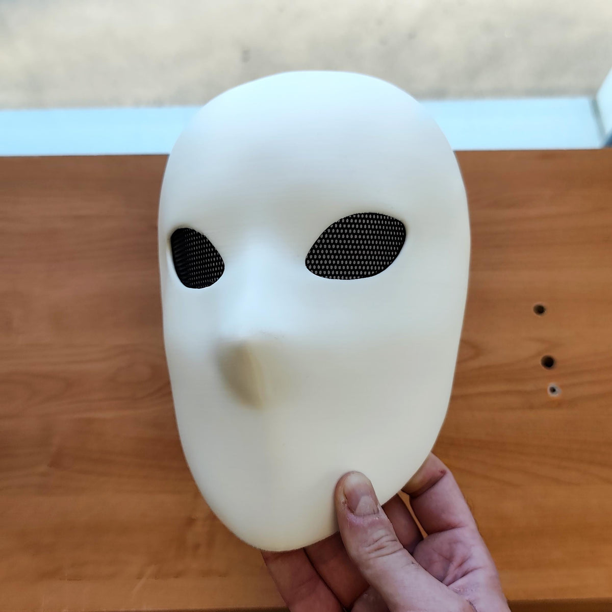 Faceless Mask featuring smooth faceless surface and narrow eye openings