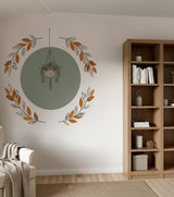 Hanging Plant Wall Decal featuring a hanging green plant inside a soft circular botanical wreath