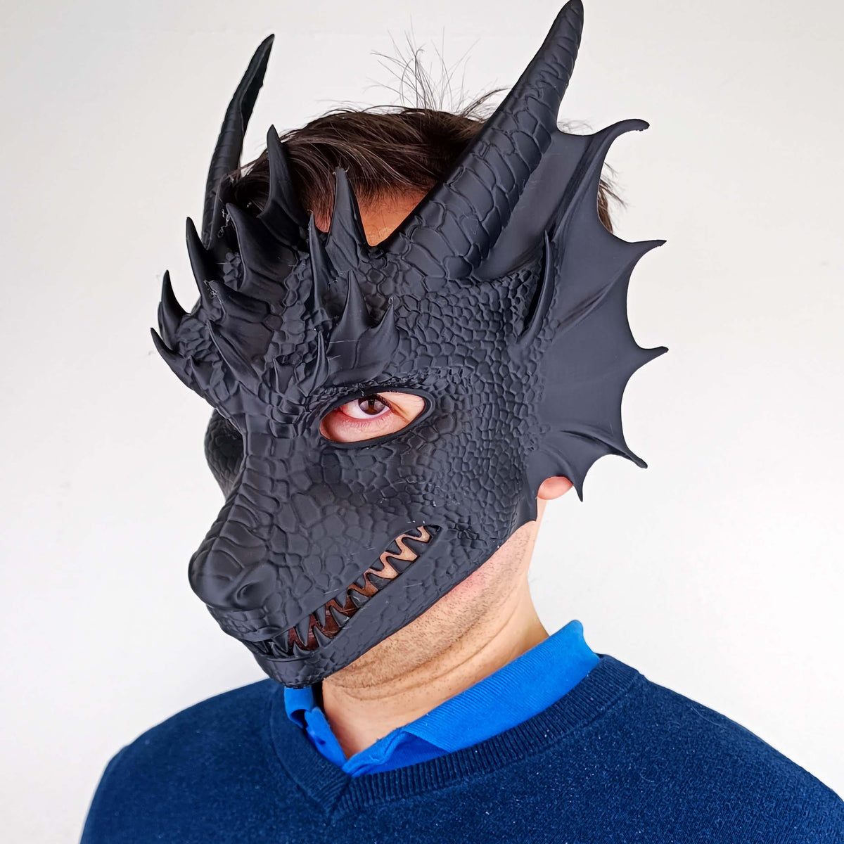 Dragon Mask featuring curved horns, scale texture and an open mouth design