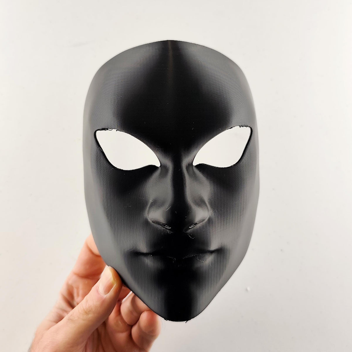 Faceless Phantom Cosplay Mask featuring smooth anonymous design and narrow eye openings