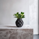 Geometric Dry Flower Vase featuring green leafy stems on a white surface