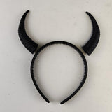 Photo of subtle curved demon horns headband with a coordinated pair of textured curved horns mounted on a lightweight band