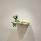 Snake Creature Wall Shelf featuring long wiggly creature character on a slim ledge and dripping supports beneath