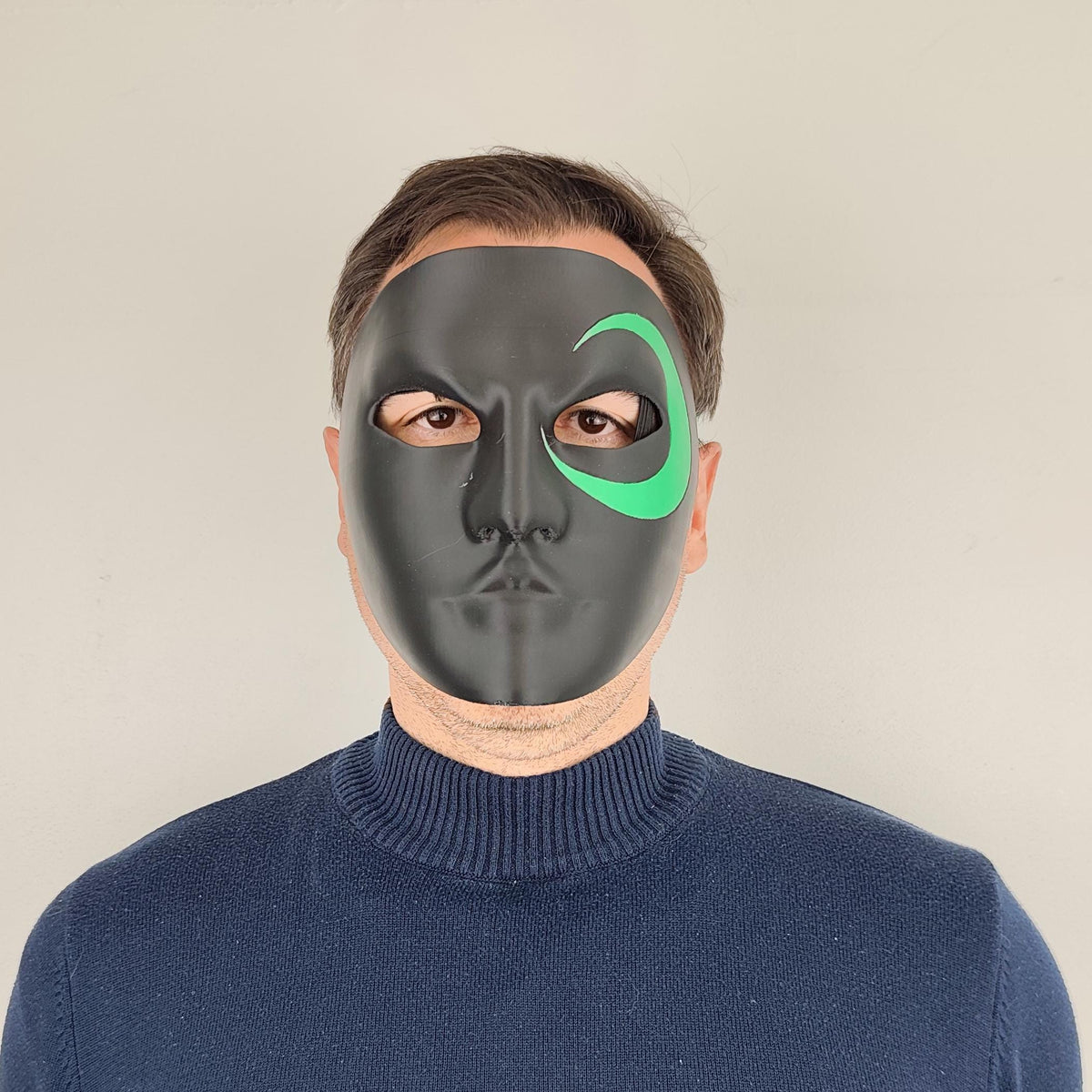 3D printed Black Full Face Cosplay Mask with green crescent design around one eye