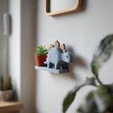 3D printed Stegosaurus Wall Shelf with small ledge, holding a plant pot