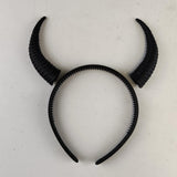 Decorative subtle curved demon horns headband showing a coordinated pair of textured curved horns mounted on a lightweight band