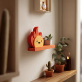 3D printed Fire Sprite Wall Shelf with flat ledge and attached smiling flame character made of matte PLA plastic
