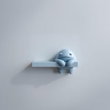 3D printed Moody Monster Wall Shelf with sad monster character integrated into a display ledge