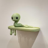 3D printed Snake Creature Wall Shelf with long wiggly creature character on a slim ledge and dripping supports beneath