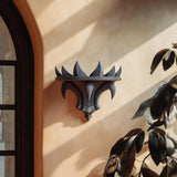 3D printed Gothic Flame Wall Shelf with curved spikes like a black crown, mounted on a warm beige wall in natural light