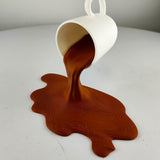 Spilled Espresso Sculpture featuring tilted cup above a broad splash shaped base