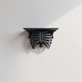 3D printed Ribcage Wall Shelf with realistic ribcage and spine forming the support under a flat rectangular ledge