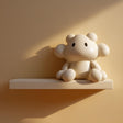 Cute Creature Wall Shelf featuring rounded creature figure integrated into the display ledge