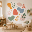 Abstract botanical wall sticker with sage green branches, coral and mustard leaves and colorful organic shapes.