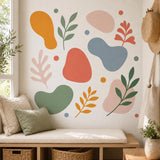 Design preview of abstract botanical wall sticker set depicting layered leaf branches and rounded abstract shapes in sage, coral and mustard