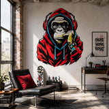 Graffiti-style gorilla wearing a red hoodie and headphones wall decal above a black sofa in an industrial loft.