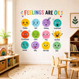 Kids feelings chart wall decal reading Feelings Are OK with twelve illustrated faces showing different emotions.