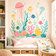 Pastel undersea wall decal with three jellyfish, five colorful fish, bubbles, coral, seaweed, starfish and seashells.