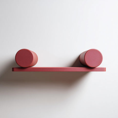 Front view of a 3D printed floating wall shelf with a flat ledge and two cylindrical supports on a neutral wall.