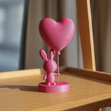 3D printed rabbit decoration with a balloon heart and a round display base.