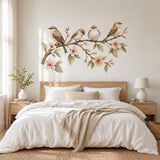 Illustrated watercolor birds wall decal with four small birds on a flowering branch with peach blossoms and green leaves