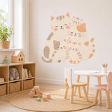 Cat family wall decal featuring five cuddling cream and peach cartoon cats with pink cheeks