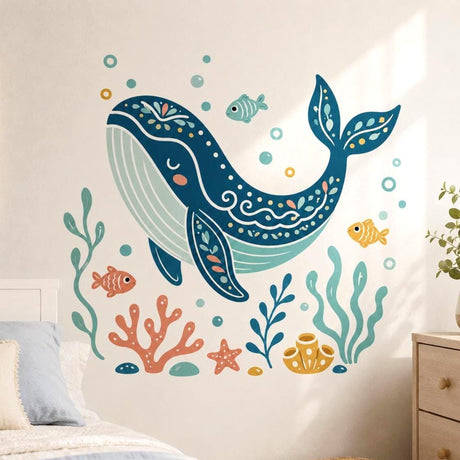 Dark teal folk-art whale wall decal with floral patterns, small fish, bubbles, coral, seaweed and a starfish.
