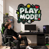 Play Mode gaming wall sticker above a computer desk, beside a person seated in a gaming chair.