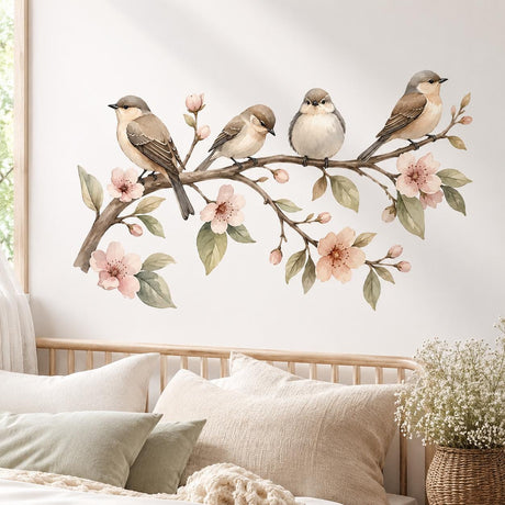 Watercolor wall sticker of four small brown and cream birds on a branch with pink blossoms and green leaves.