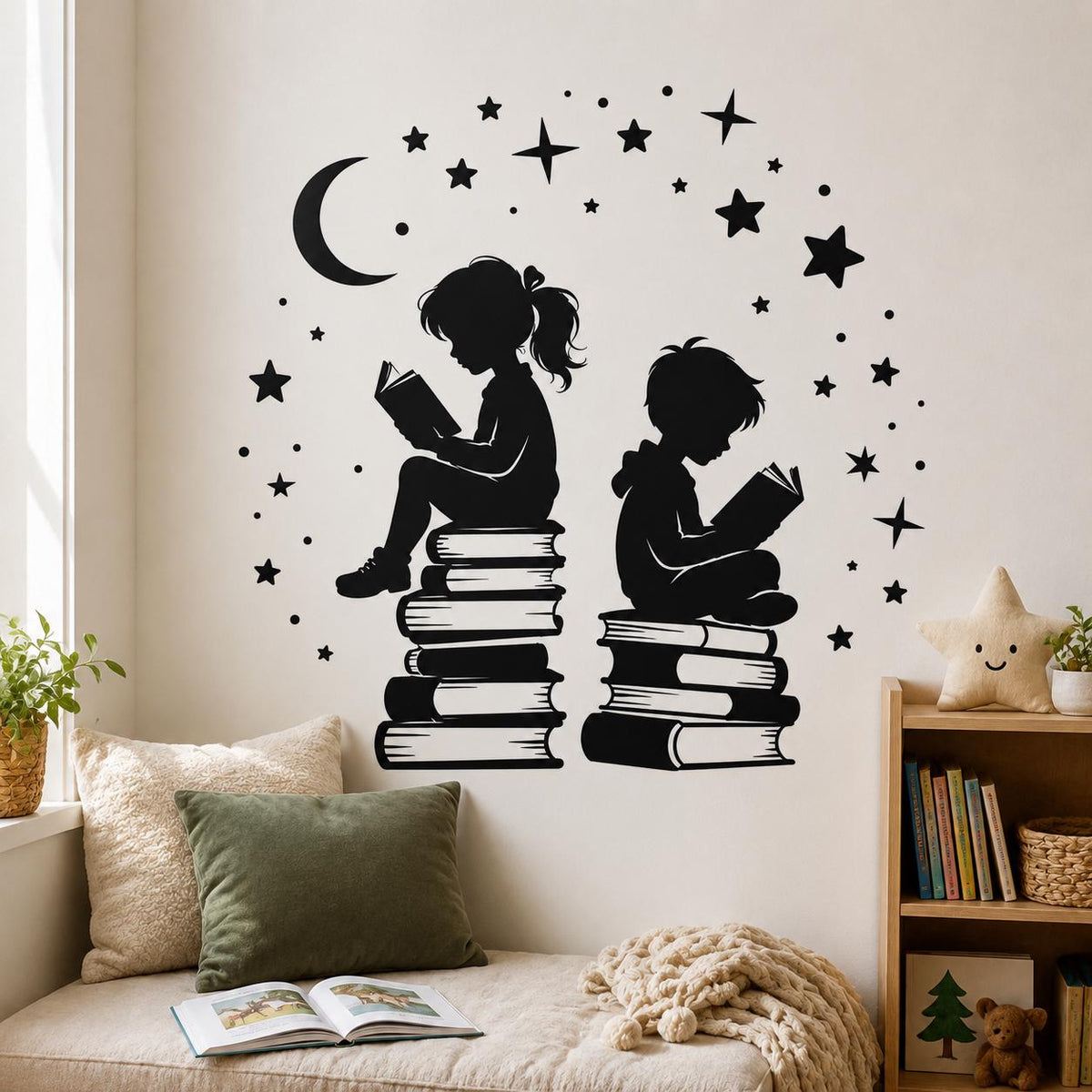Black children reading silhouette wall decal with a crescent moon and stars above a cream sofa in a reading nook.