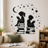 Black children reading silhouette wall decal with a crescent moon and stars above a cream sofa in a reading nook.