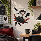 Gothic bat-winged girl decal displayed above a small desk with a lamp and books.