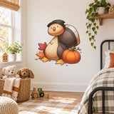 Autumn turtle and pumpkin wall decal next to a children's bed and basket of stuffed animals.