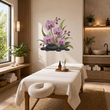 Purple orchid and black stone wall sticker above a spa massage bed in a warm treatment room.