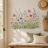 Watercolor wildflower wall decal illustrating pink, coral, yellow and violet meadow flowers among tall green grasses