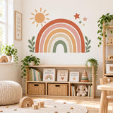 Boho rainbow and sun wall sticker above toy storage shelves with wicker baskets.