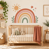 Terracotta and sage rainbow wall decal with sun and leaves above a wooden nursery crib.